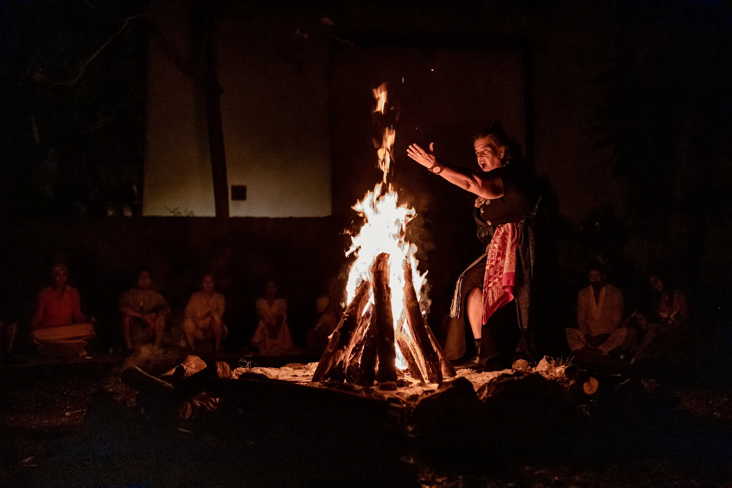 Abuela Martha Pico beside the fire during a ceremonial gathering